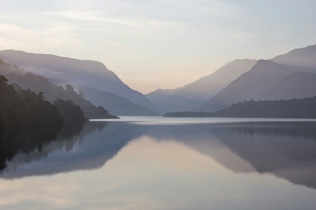 Calm water with a soft mountain in the distance
