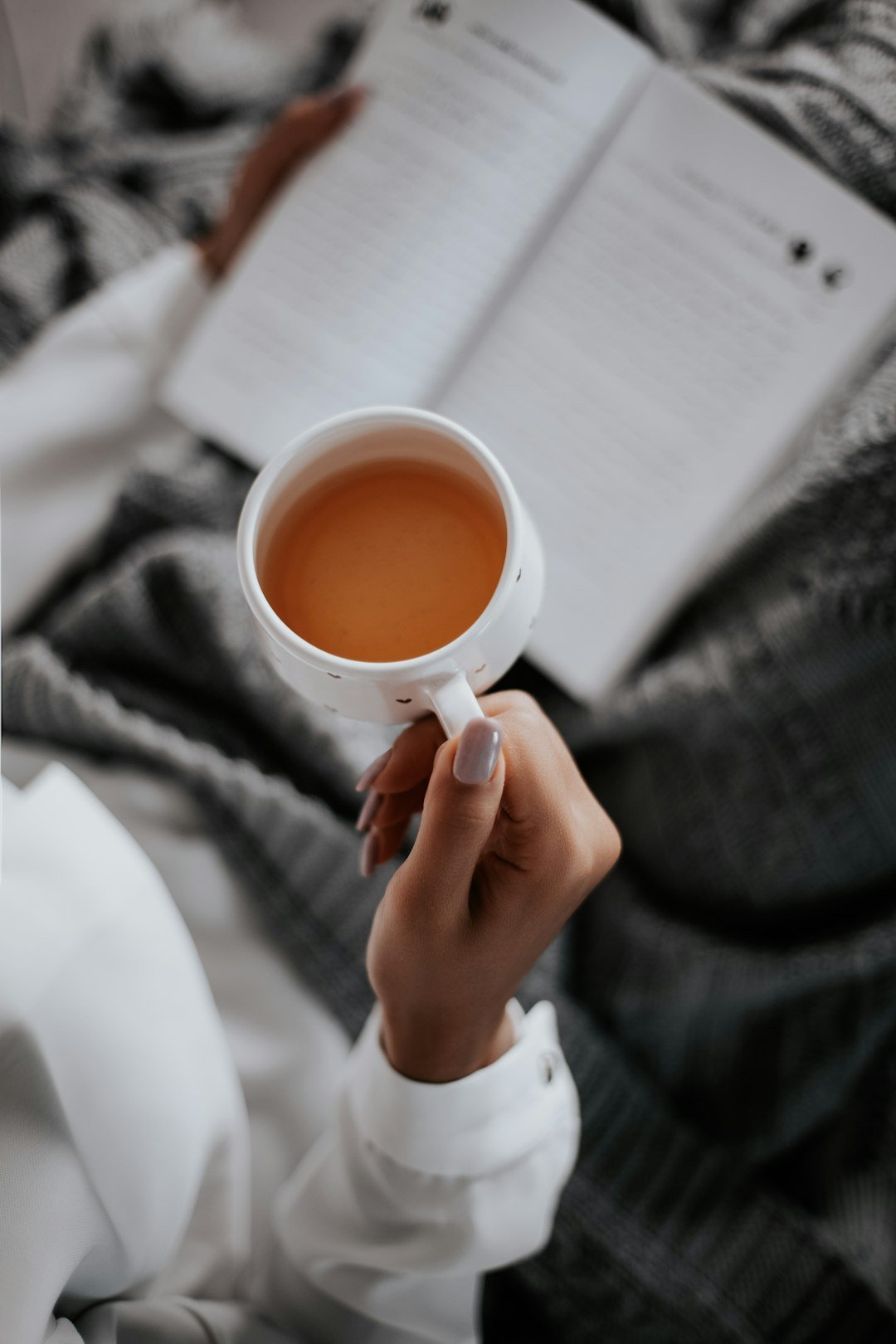 Hands resting around a white ceramic mug, a moment of rest